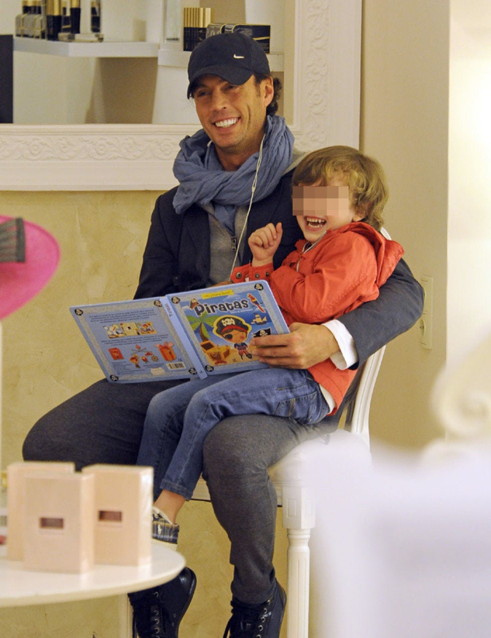 Cap, Sitting, Happy, Jeans, Sharing, Baseball cap, Denim, Reading, Lap, Publication, 