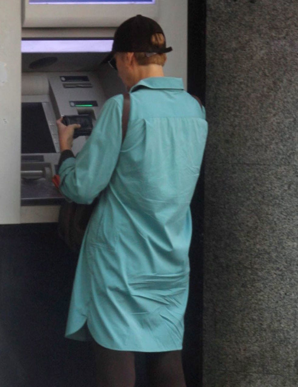 Cap, Sleeve, Human body, Standing, Joint, Baseball cap, One-piece garment, Machine, Service, Cricket cap, 