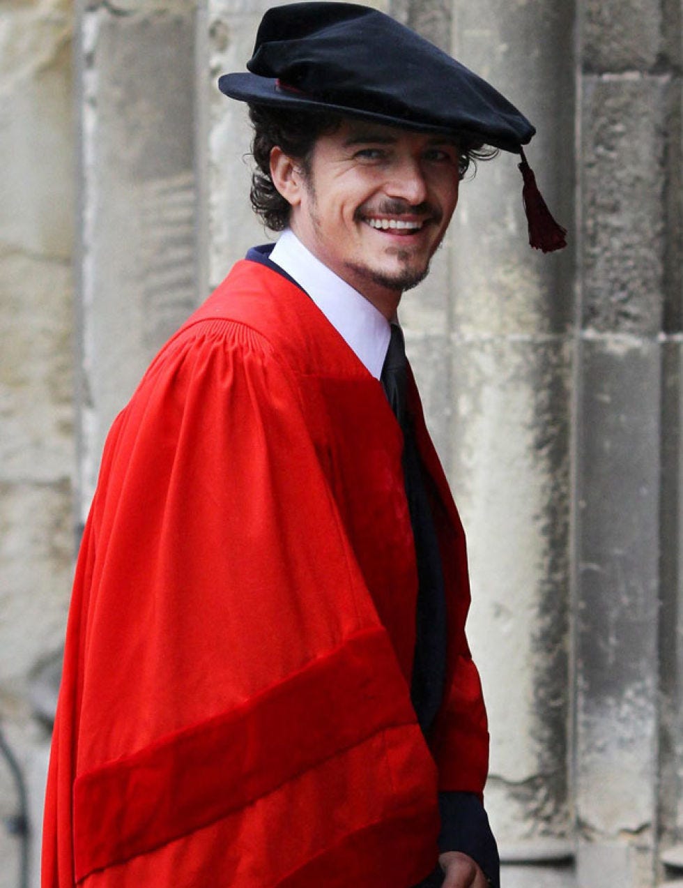 Sleeve, Collar, Standing, Hat, Formal wear, Headgear, Costume accessory, Facial hair, Temple, Academic dress, 