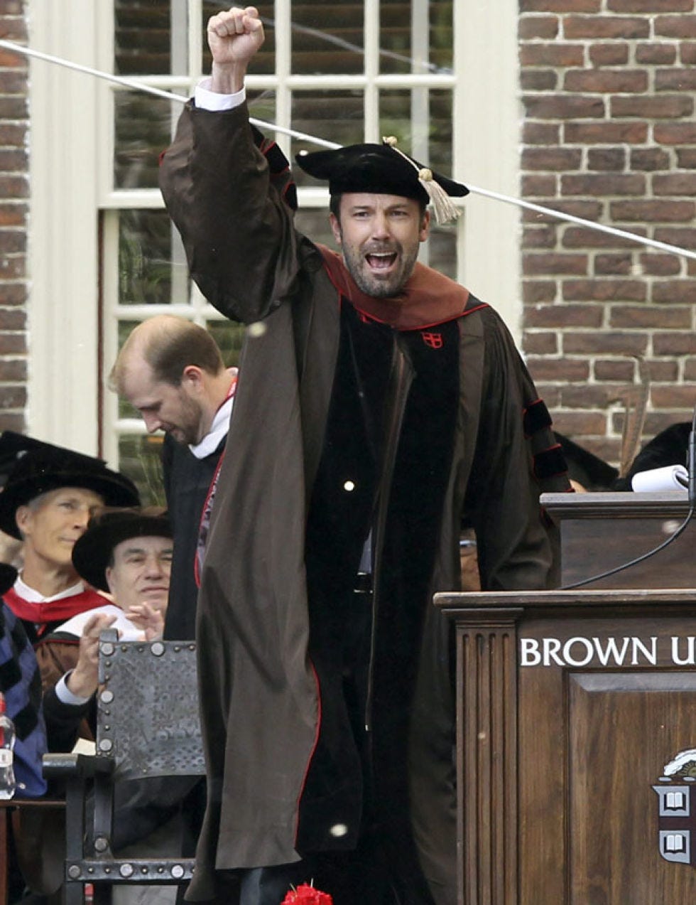 Face, Hat, Headgear, Costume accessory, Podium, Costume, Academic dress, Public speaking, Lectern, Costume hat, 