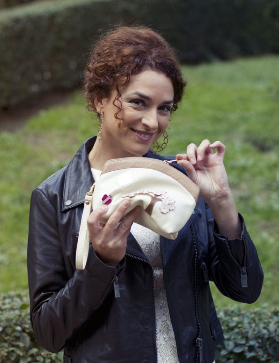 Hand, Mammal, Happy, People in nature, Jacket, Jewellery, Tooth, Brown hair, Rugby ball, Fruit, 
