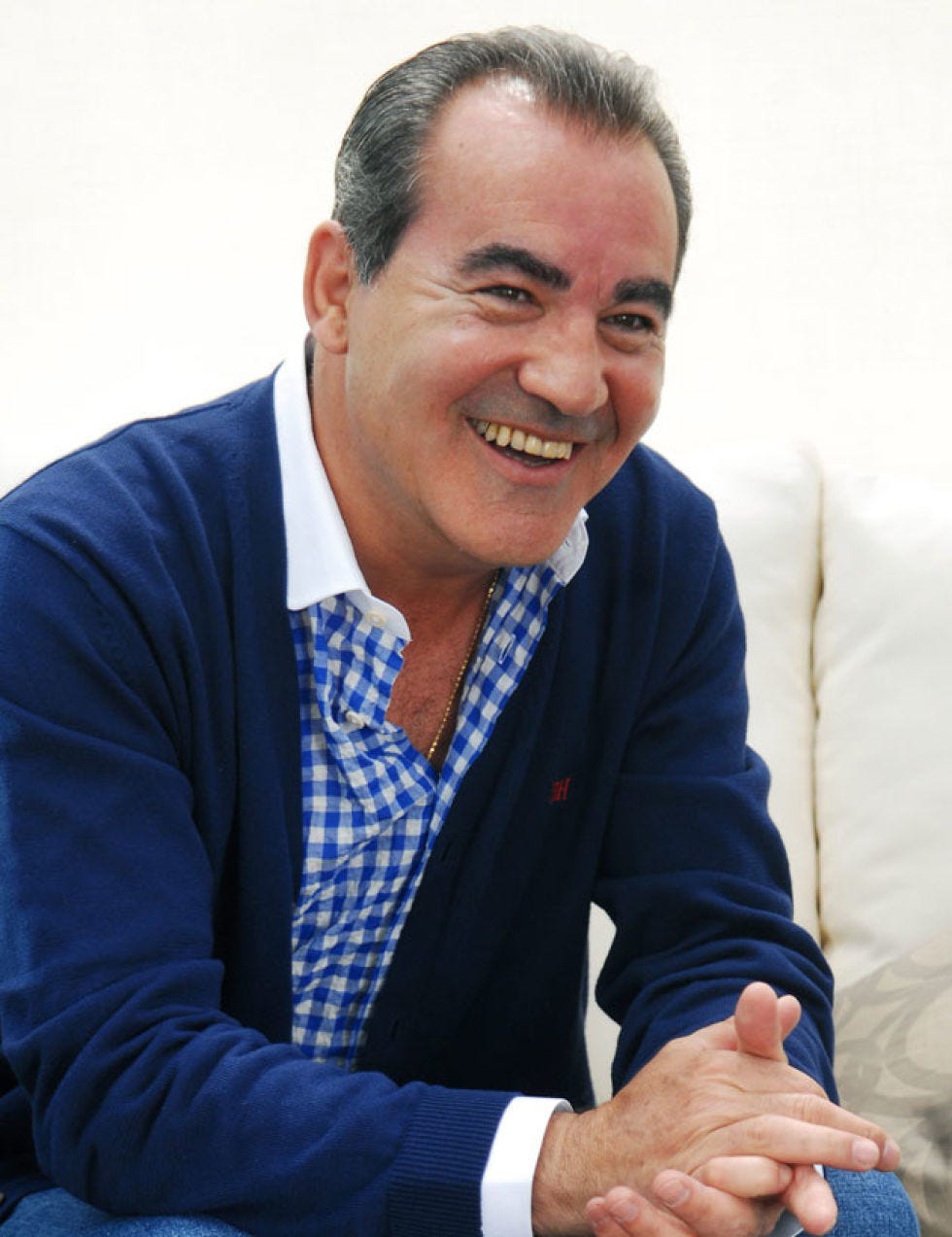 Finger, Smile, Sitting, Wrist, Dress shirt, Tooth, Comfort, Nail, Cuff, Thumb, 