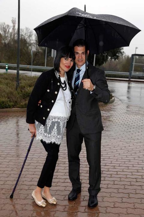 Clothing, Coat, Umbrella, Trousers, Shirt, Standing, Photograph, Collar, Outerwear, Formal wear, 