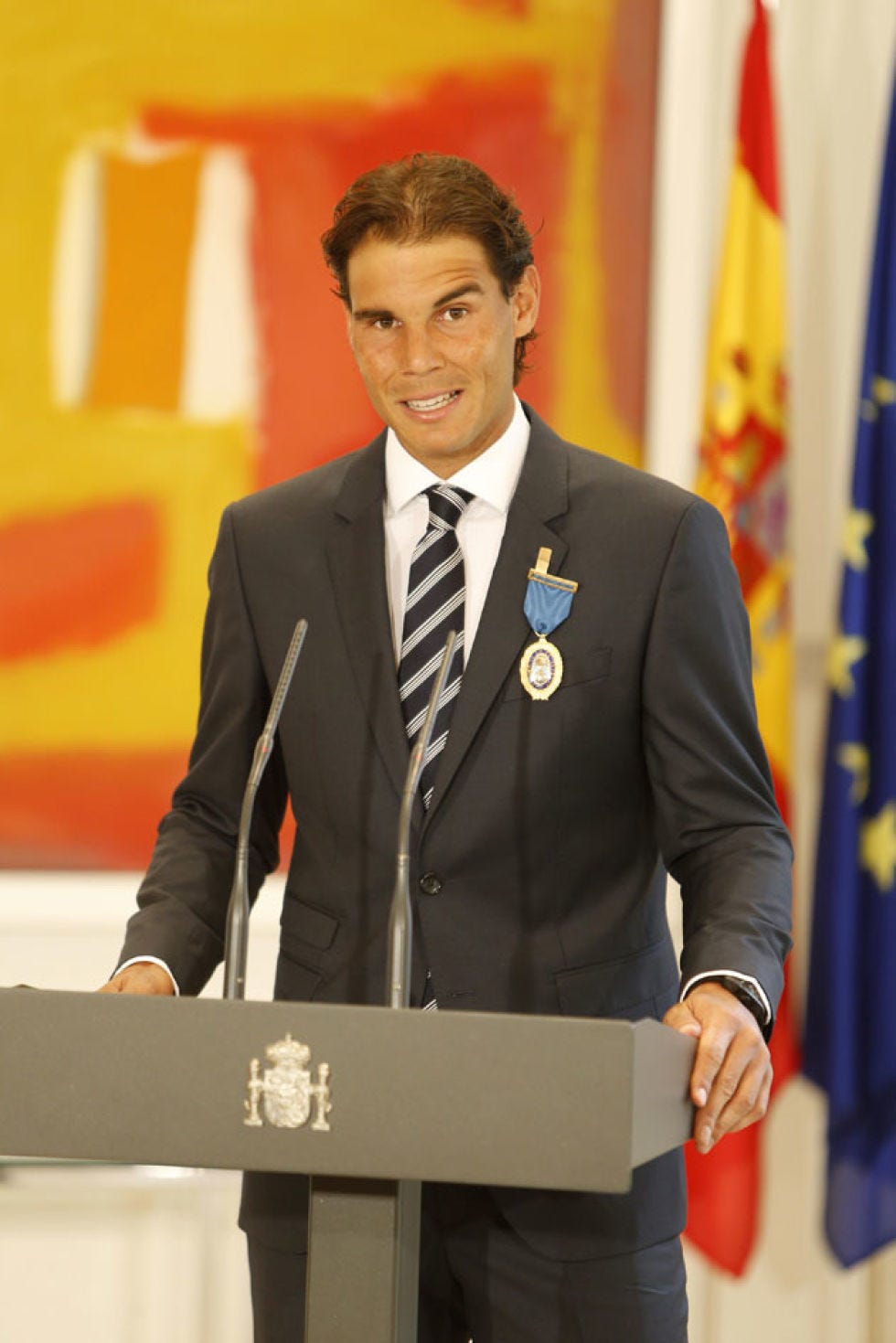 Audio equipment, Microphone, Dress shirt, Collar, Podium, Flag, Shirt, Standing, Public speaking, Lectern, 