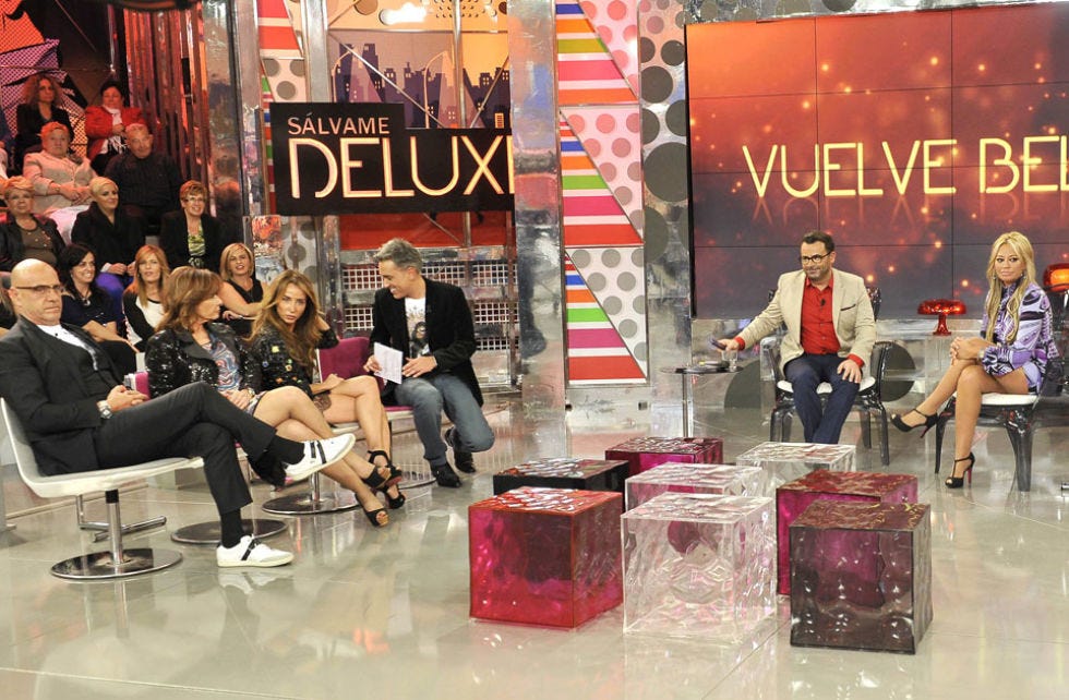Leg, Jeans, Logo, Advertising, Stage, Banner, Coffee table, Baggage, Couch, Television program, 