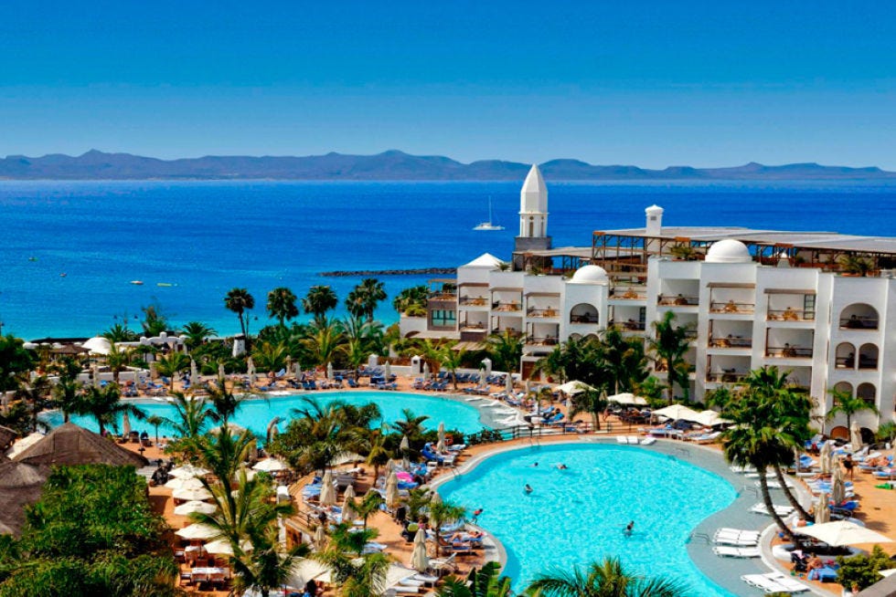Body of water, Coastal and oceanic landforms, Resort, Tourism, Water, Landscape, Swimming pool, Tree, Beach, Woody plant, 