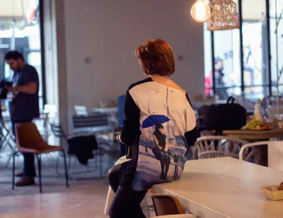 Human body, Furniture, Table, Light fixture, Luggage and bags, Bag, Back, Wood flooring, Restaurant, Handbag, 