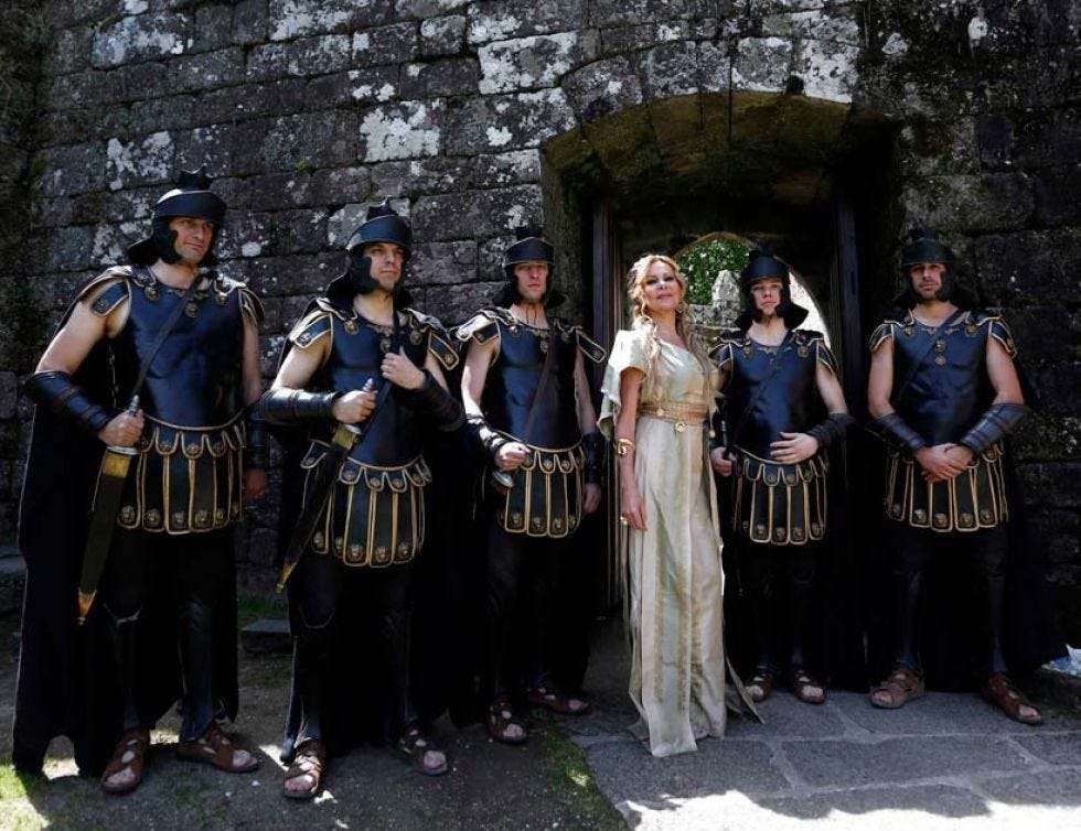 Dress, Costume, Costume design, Stone wall, Victorian fashion, Gown, Belt, 