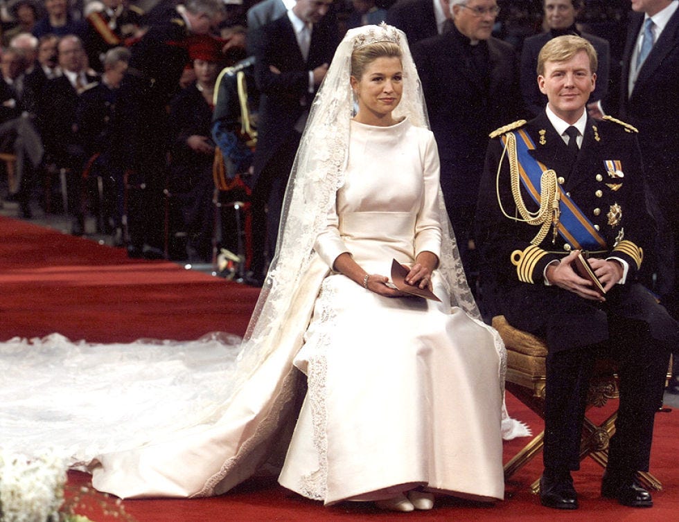 Event, Coat, Dress, Suit, Outerwear, Formal wear, Gown, Bridal veil, Bridal clothing, Flooring, 