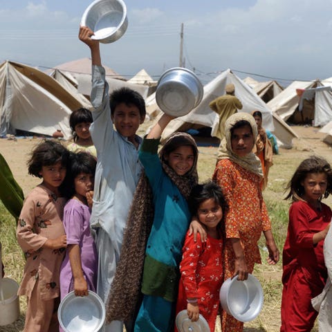 Smile, People, Community, Tent, Sharing, Wind instrument, Tradition, Helicon, Sousaphone, Dishware, 