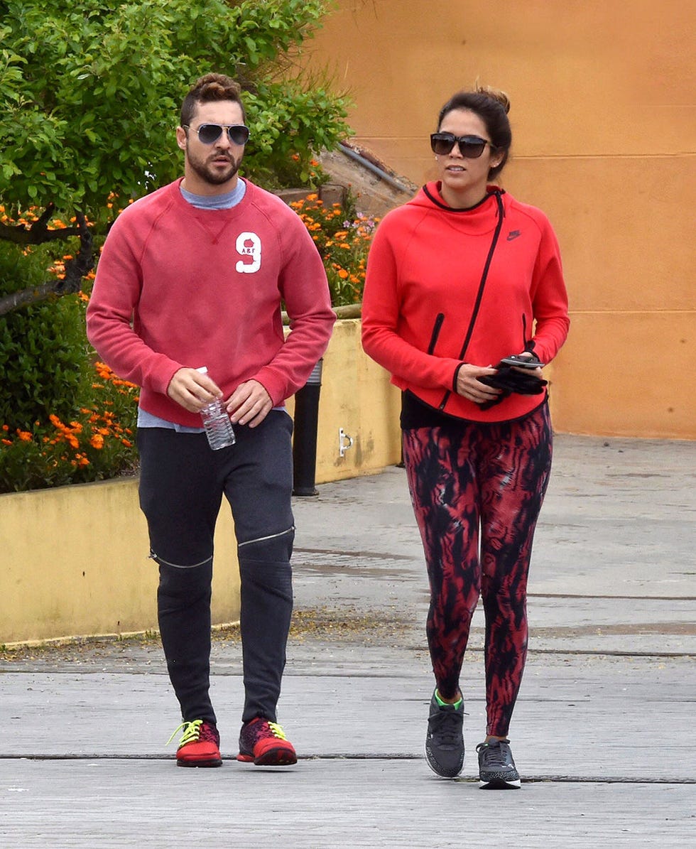 Clothing, Eyewear, Sleeve, Trousers, Red, Textile, Outerwear, Standing, Sunglasses, T-shirt, 