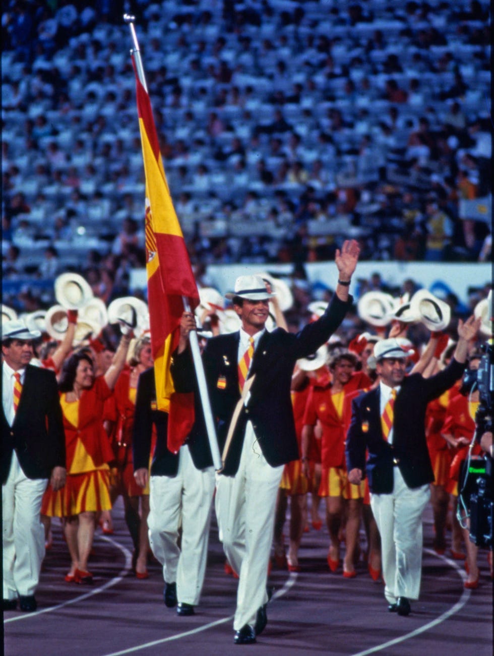 Flag, Uniform, Stadium, Fan, Parade, Audience, Crew, Military person, Color guard (flag spinning), 