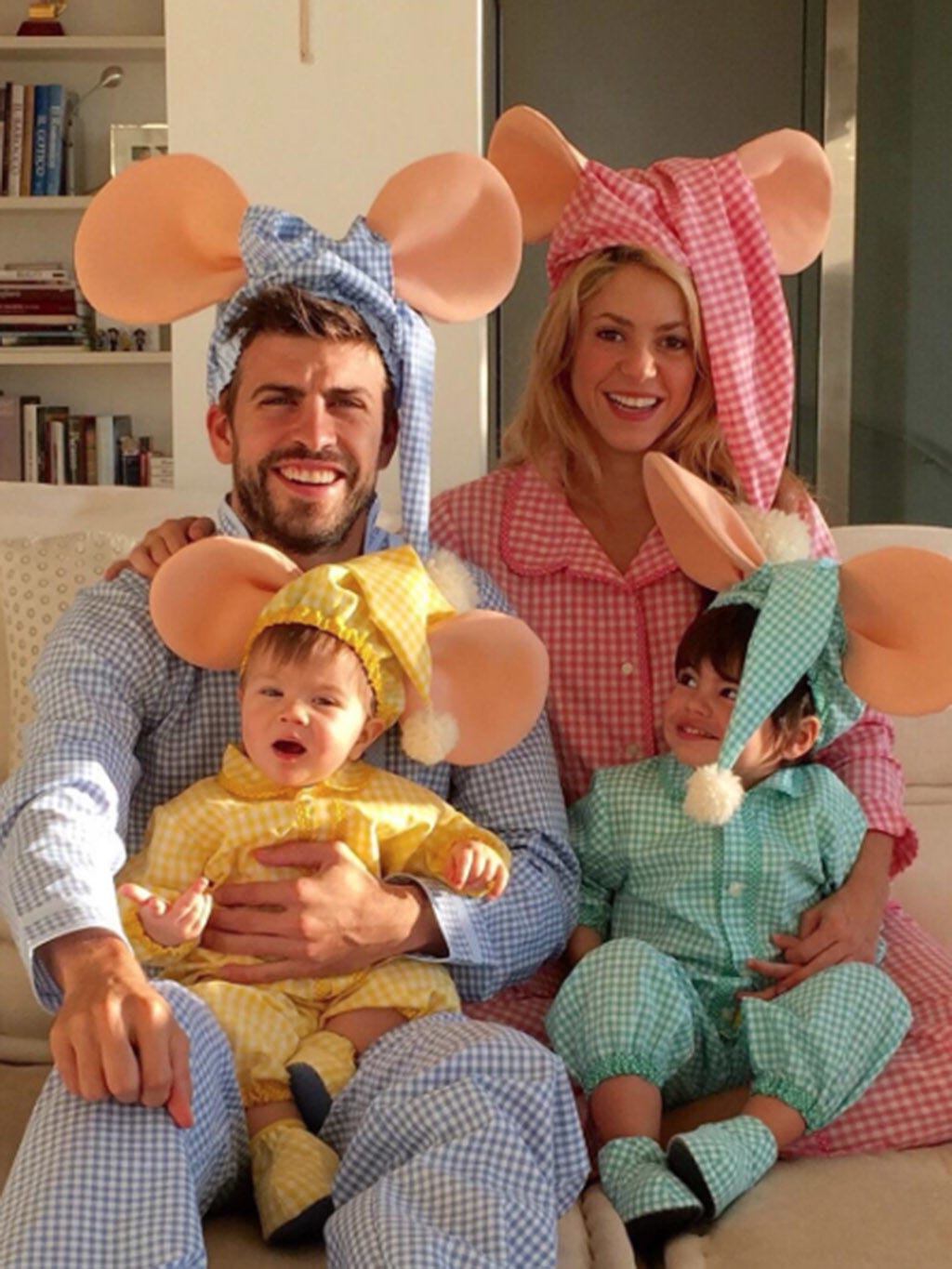 Human, Smile, Happy, Costume accessory, Headgear, Comfort, Baby & toddler clothing, Shelf, Lap, Bookcase, 