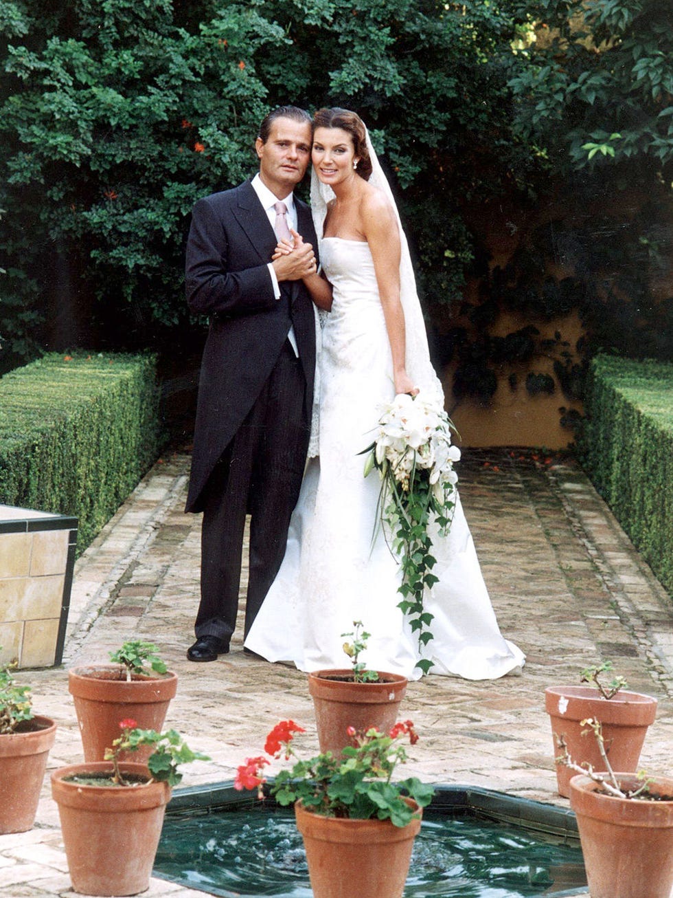 Clothing, Flowerpot, Coat, Plant, Trousers, Bridal clothing, Dress, Suit, Outerwear, Formal wear, 