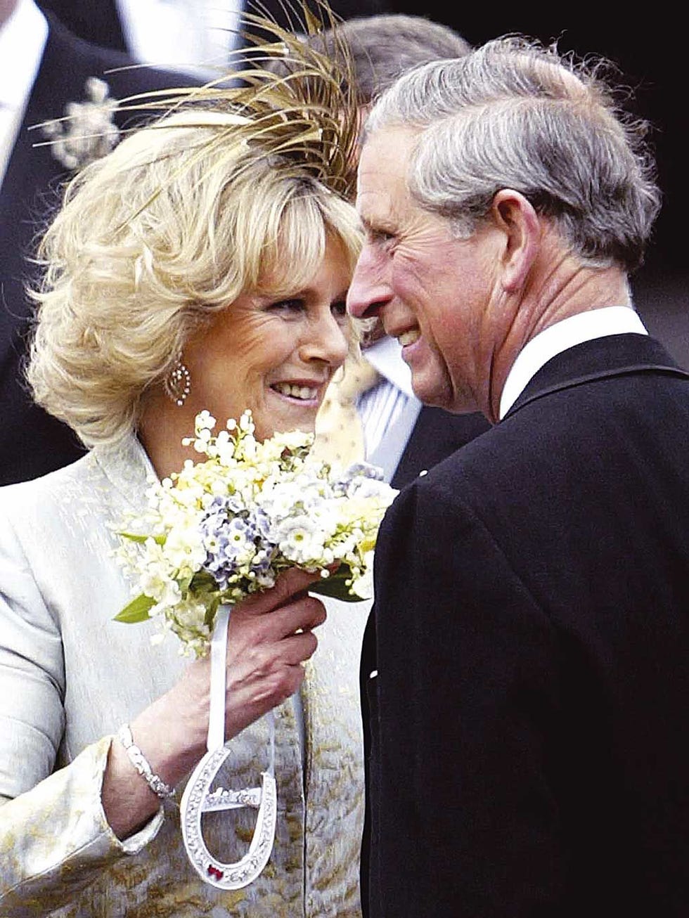 Clothing, Happy, Coat, Suit, Formal wear, Facial expression, Bouquet, Interaction, Petal, Cut flowers, 