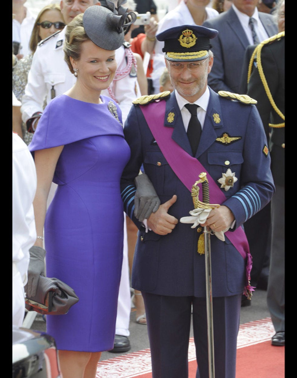 Hat, Dress, Formal wear, Purple, Cap, Uniform, Blazer, Costume accessory, One-piece garment, Tradition, 
