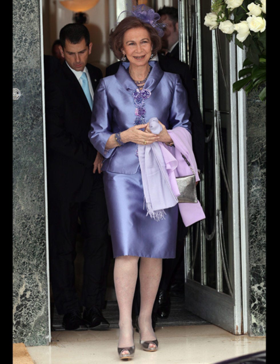 Outerwear, Coat, Formal wear, Suit, Blazer, Suit trousers, One-piece garment, Foot, Necklace, Day dress, 