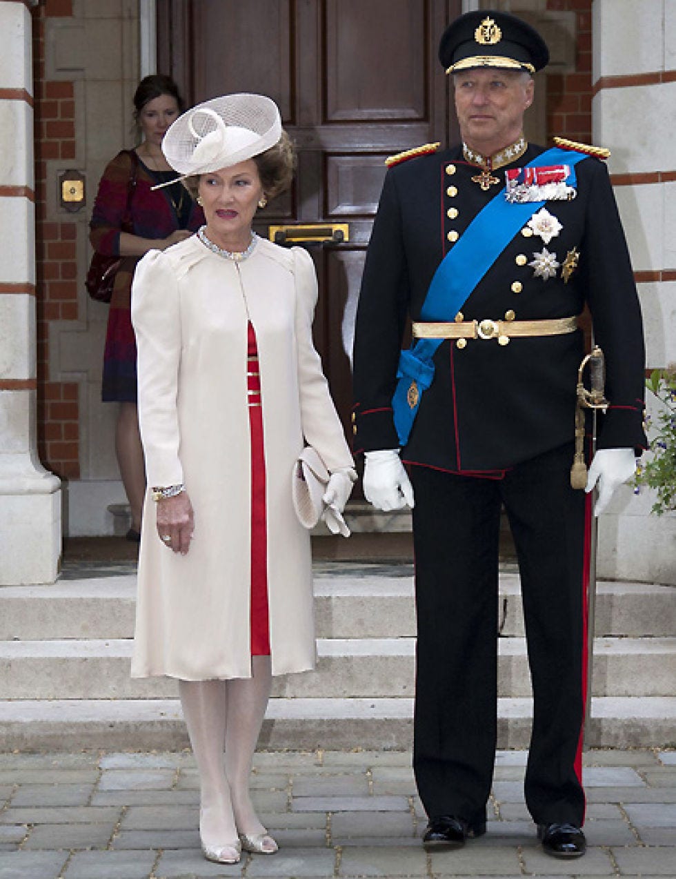 Footwear, Hat, Standing, Coat, Collar, Uniform, Dress shirt, Headgear, Blazer, Sun hat, 