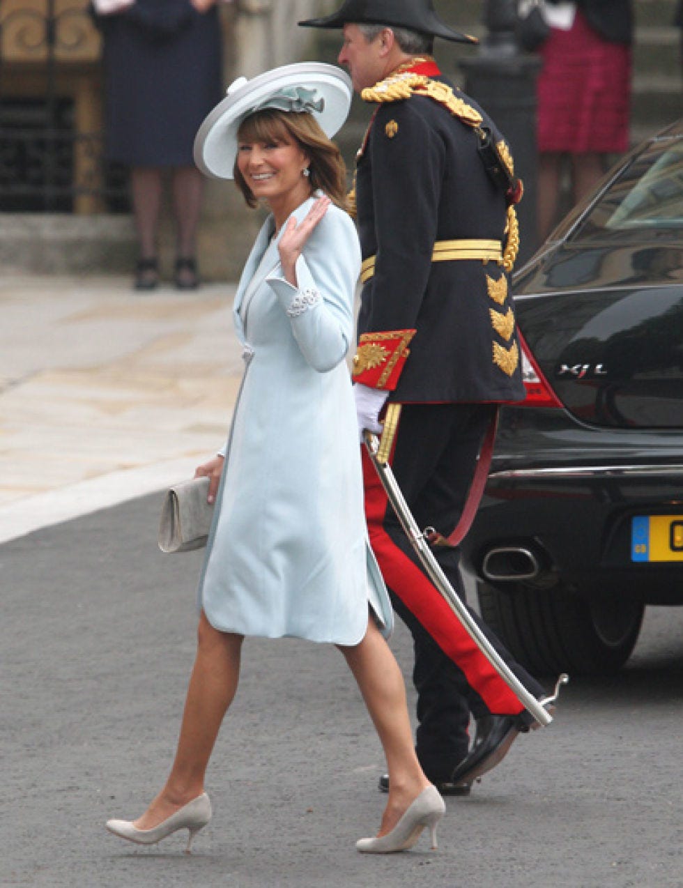 Vehicle registration plate, Hat, Dress, Shoe, Outerwear, Coat, Style, Formal wear, Suit, Automotive exterior, 