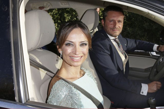 Motor vehicle, Smile, Vehicle, Automotive design, Photograph, Vehicle door, Car seat, Suit, Car, Formal wear, 