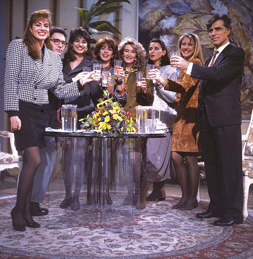 Smile, Table, Furniture, Bouquet, Flower Arranging, Floristry, Distilled beverage, Cut flowers, Suit trousers, Barware, 