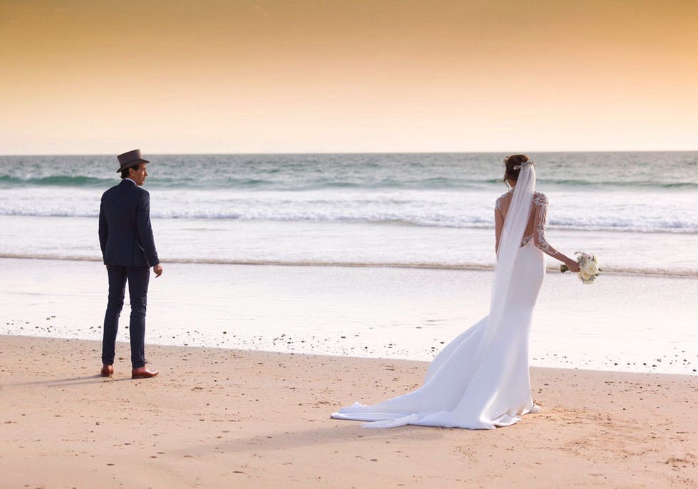 Body of water, Coastal and oceanic landforms, People on beach, Shore, Sand, Photograph, Standing, Ocean, Dress, Beach, 