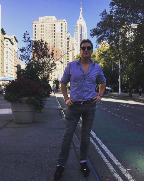 Flowerpot, Tower, Shirt, Shoe, Standing, Denim, Building, T-shirt, Sunglasses, Street fashion, 