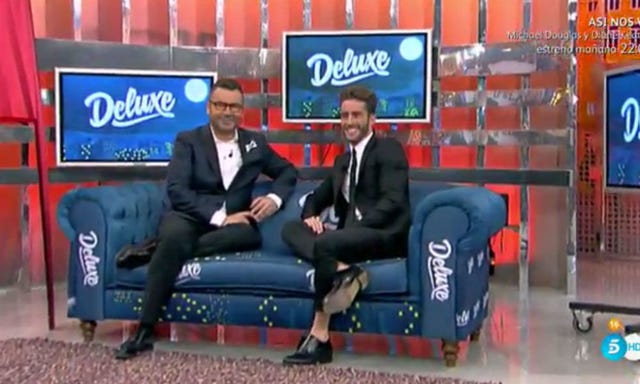 Clothing, Leg, Blue, Display device, Couch, Formal wear, Suit, Logo, Sitting, Electric blue, 