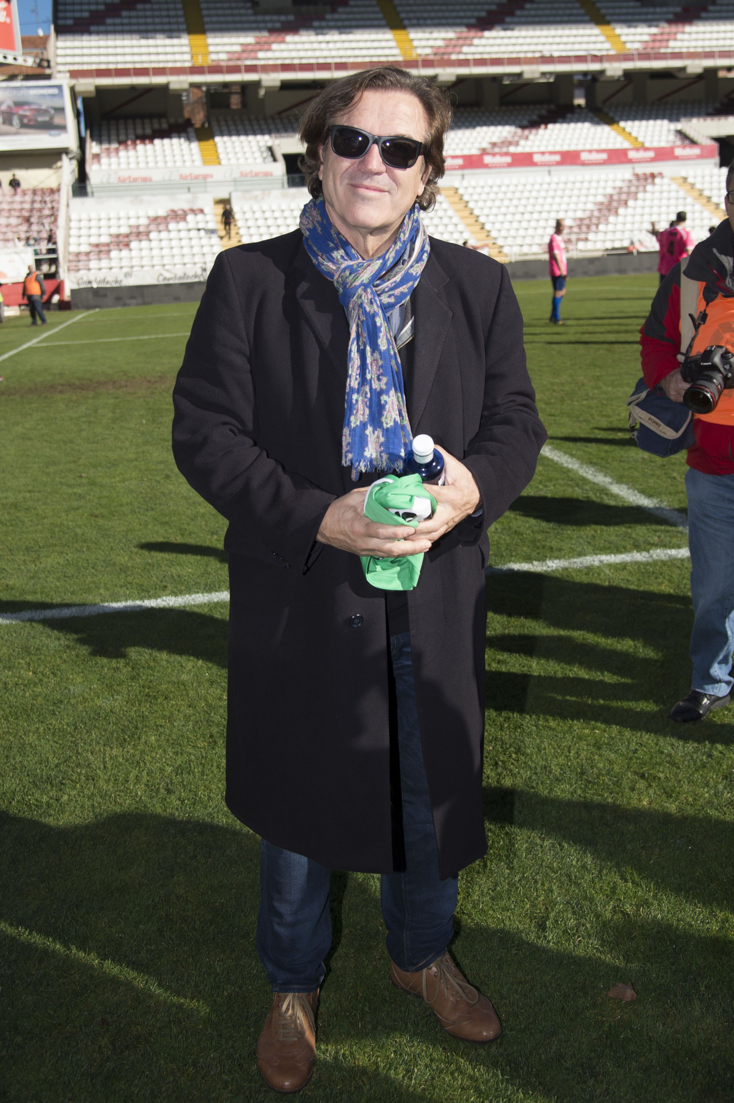 Sunglasses, Stadium, Scarf, Foot, Sandal, Scoreboard, Slipper, Arena, 