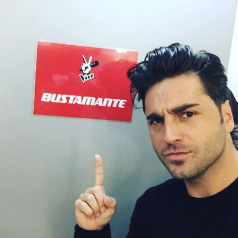 Finger, Chin, T-shirt, Thumb, Wrist, Facial hair, Jaw, Gesture, Logo, Black hair, 