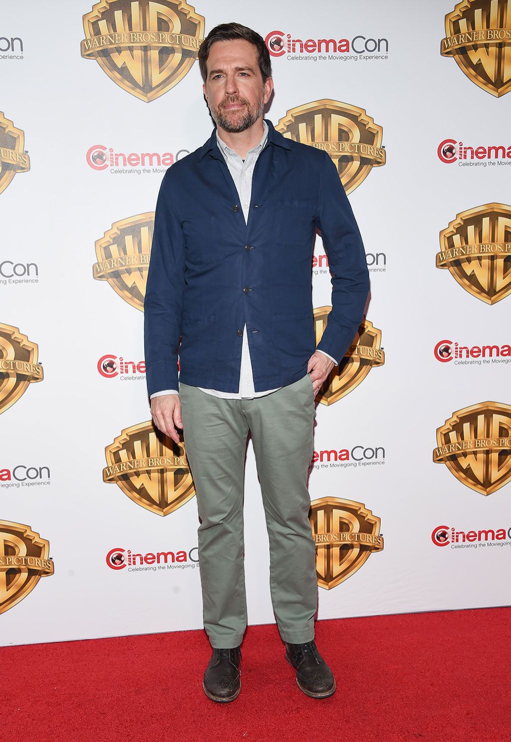 Dress shirt, Collar, Facial hair, Beard, Logo, Moustache, Drum, Suit trousers, Pocket, Emblem, 