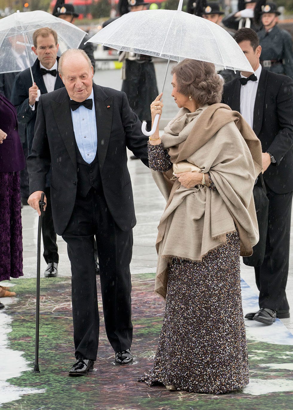 Fashion, Event, Formal wear, Outerwear, Ceremony, Fashion accessory, Umbrella, Gesture, Suit, 