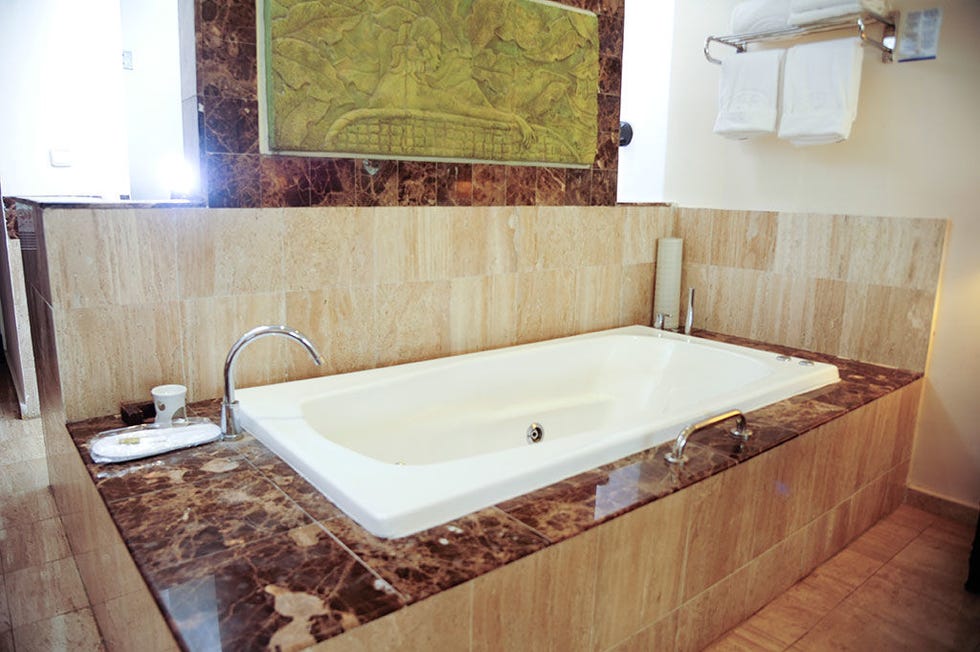 Bathtub, Floor, Room, Property, Flooring, Plumbing fixture, Wall, Tile, Interior design, Bathtub accessory, 