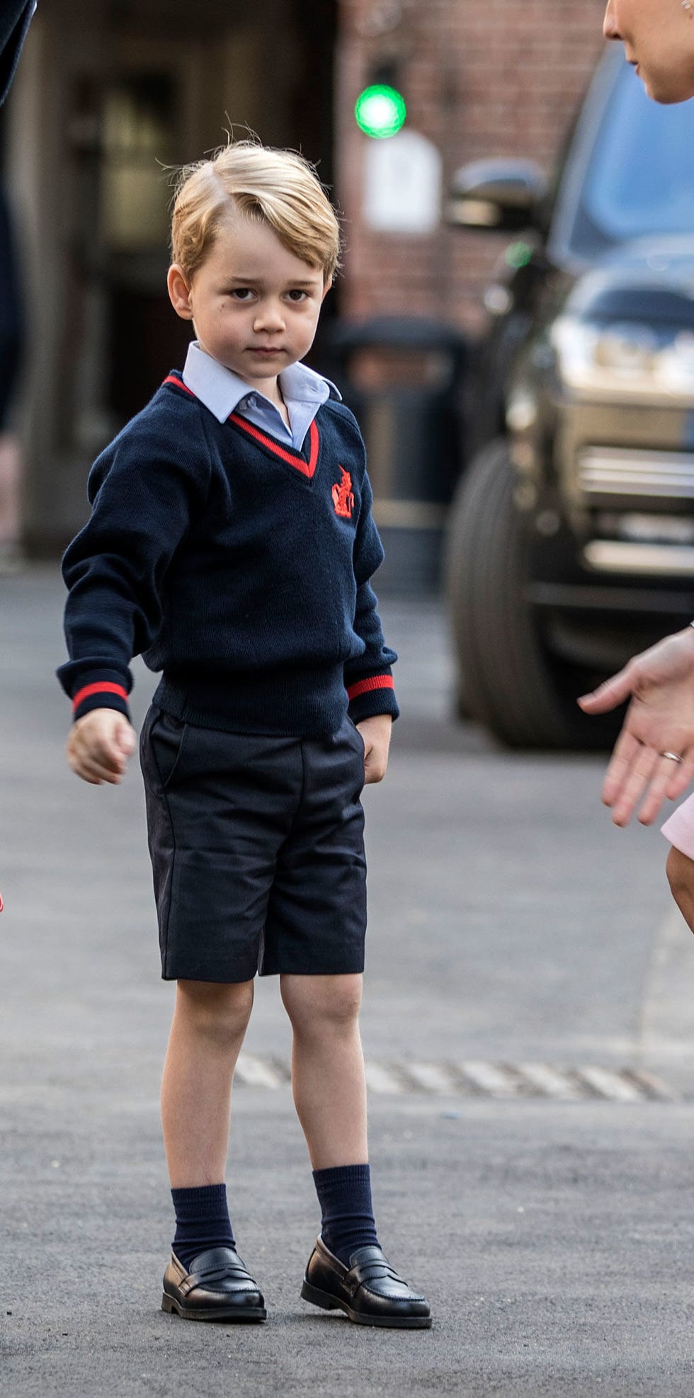 Clothing, Uniform, Street fashion, Fashion, Standing, Child, Footwear, Outerwear, Vehicle, School uniform, 
