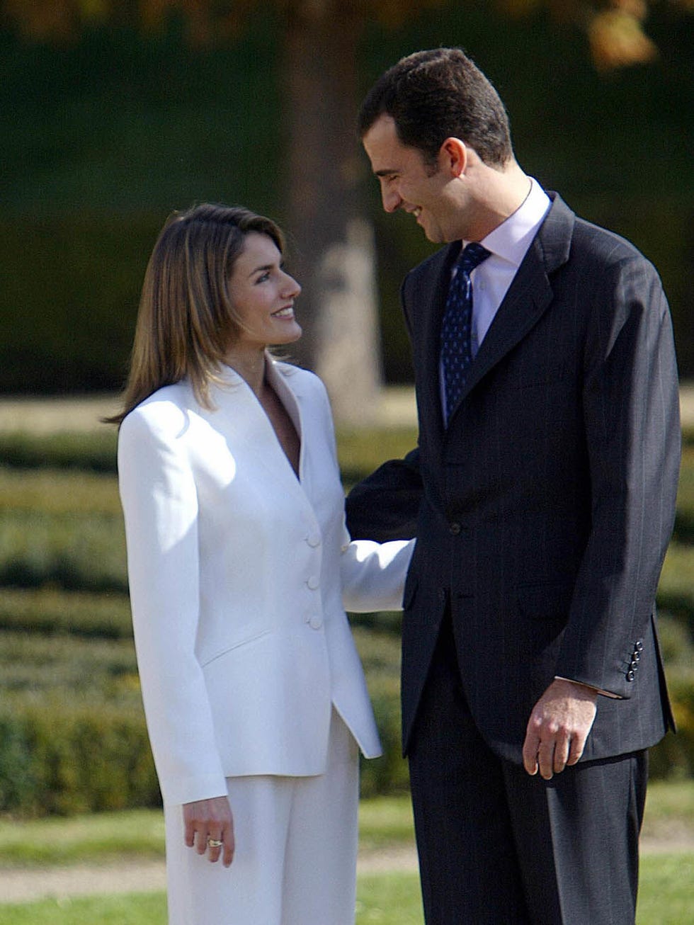 Suit, Formal wear, Tuxedo, Gesture, White-collar worker, Uniform, Event, Outerwear, Blazer, Dress, 