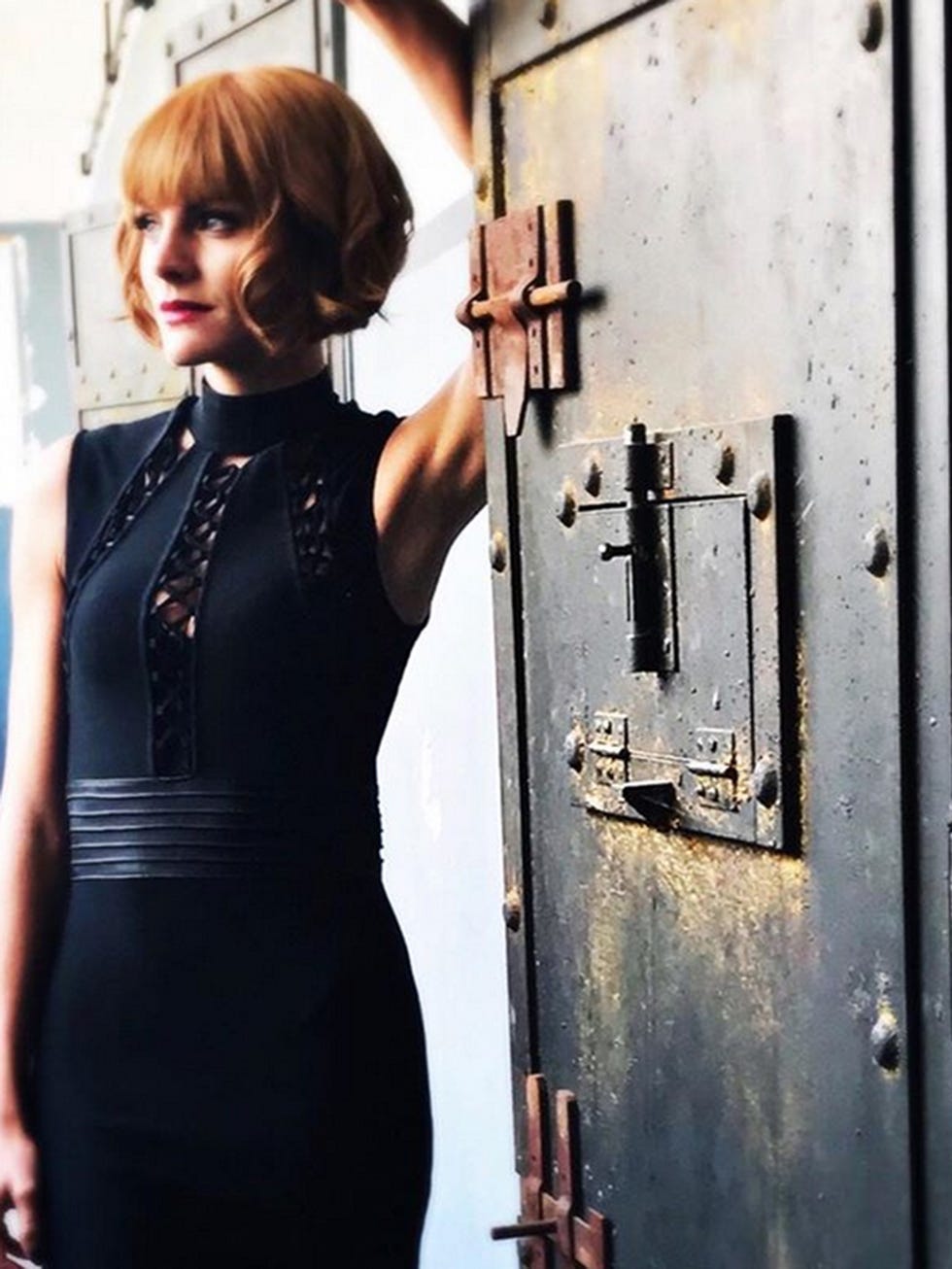 Dress, Skin, Hairstyle, Standing, Fashion, Shoulder, Little black dress, Blond, Neck, Door, 