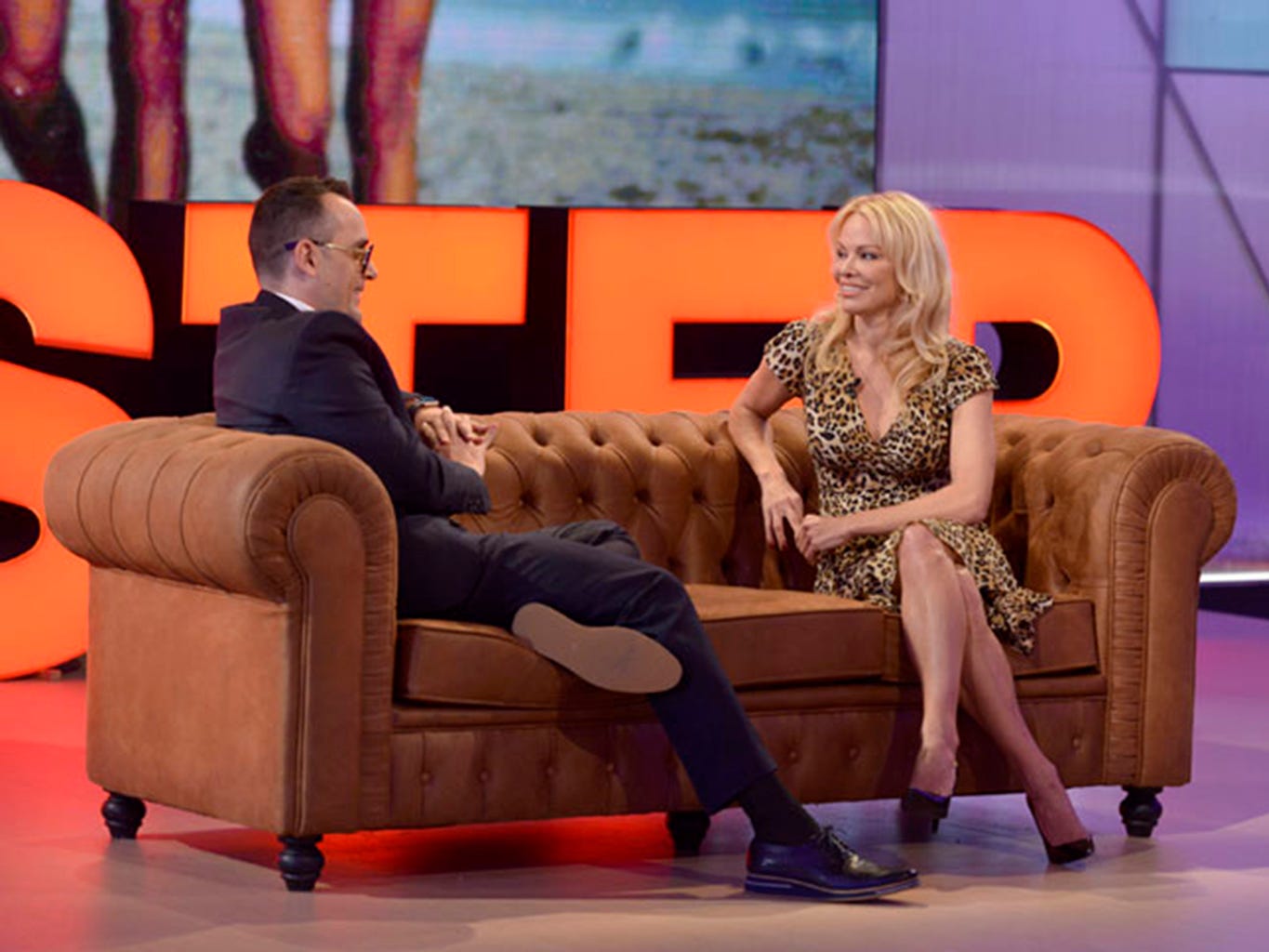 Leg, Couch, Thigh, Furniture, Blond, Television program, Human body, Fun, Long hair, Sitting, 
