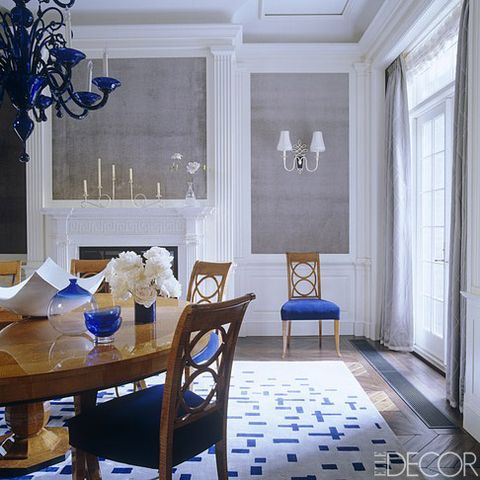 The dining room walls are inset with velvet, the sconce is 1940s by Rene Prou and the silk rug is designed by Diamond and Baratta