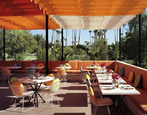 Furniture, Table, Orange, Restaurant, Chair, Shade, Outdoor table, Outdoor furniture, Design, Outdoor structure, 