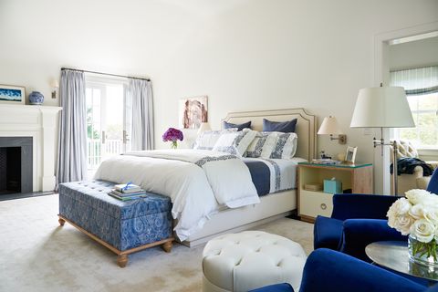 Alec and Hilaria's master bedroom features a bed by Charles Beckley, bedding by Sferra and Frette and nightstands from Profiles. The blue velvet club chairs are a custom design by Daniel Romanoff.