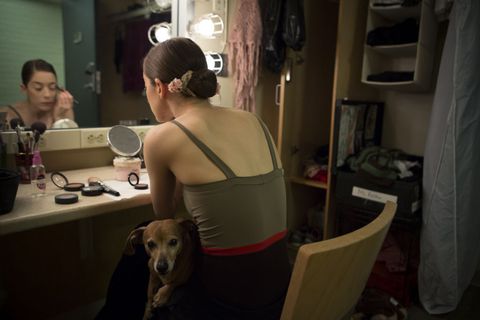 Principal dancer Rebecca Krohn applies stage makeup in her dressing room before the show. Dancers are allowed bring their dogs with them to both rehearsals and shows, so it's not uncommon to see five or six dogs roaming around near the dressing rooms.