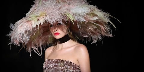 Hairstyle, Strapless dress, Feather, Headgear, Fashion model, Costume accessory, Fashion, Natural material, Animal product, Model, 