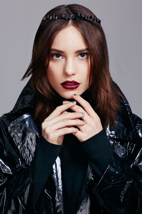 <p>Dark and dramatic doesn't have to mean one-dimensional, makeup artist Michael Anthony says. Exfoliate lips with a soft toothbrush or a sugar scrub, hydrate with a balm, and blot using a piece of paper—not a tissue, which can leave fuzzy particles behind. Next, fill in your entire mouth with a bold berry hue (like <a href="http://www.amazon.com/Maybelline-New-York-Studio-Color/dp/B00YJJXCJO/ref=sr_1_1?ie=UTF8&qid=1448912752&sr=8-1&keywords=Maybelline+New+York+Lip+Studio+Color+Blur" target="_blank">Maybelline New York Lip Studio Color Blur Matte Lip Pencil in Plum, Please</a>), blot, and reapply. Between each layer, use the silicone tip at the opposite end of the pencil to press the creamy formula into your pout. "It's not about swiping—it's about pushing the pigment into the lips so that the color is saturated and stays put," Anthony explains. To create the illusion of fullness, run a short band of bright red (like <a href="http://www.amazon.com/Maybelline-New-York-Studio-Color/dp/B00YJJXCJO/ref=sr_1_1?ie=UTF8&qid=1448912844&sr=8-1&keywords=Maybelline+New+York+Lip+Studio+Color+Blur" target="_blank">Maybelline New York Lip Studio Color Blur in Partner in Crimson</a>) horizontally across the center of your mouth and blend it toward the perimeter with the smudger.
</p><p><em>Trench coat: Tome; Bodysuit: Jill Stuart</em>
</p><p><img src="https://secure.insightexpressai.com/adServer/adServerESI.aspx?bannerID=549706&script=false&rnd=[%%CACHEBUSTER%%]&tag=img" width="0" height="0" style="visibility: hidden !important; height: 1px; width: 1px; display: none !important; opacity: 0 !important; background-position: 0px 0px;"></p>