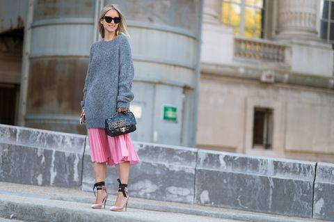 <p>Take a chance on new silhouettes and pair an oversized sweater with a midi skirt to create a faux dropped waistline. A pair of high heels keeps the outfit from looking too dowdy. </p>