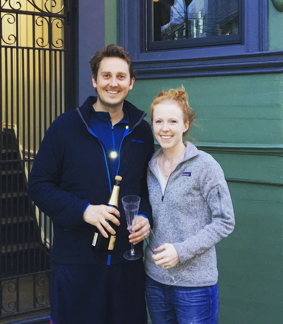Laura Turner and her husband in front of their house
