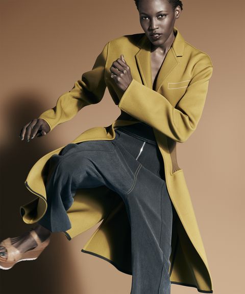 <p><em>Bonded-wool coat, $4,750, silk canvas trousers, $1,550, both, Céline, at Céline, NYC. Gold ring, David Yurman, $3,400. Leather sandals, Stuart Weitzman, $398.</em></p>