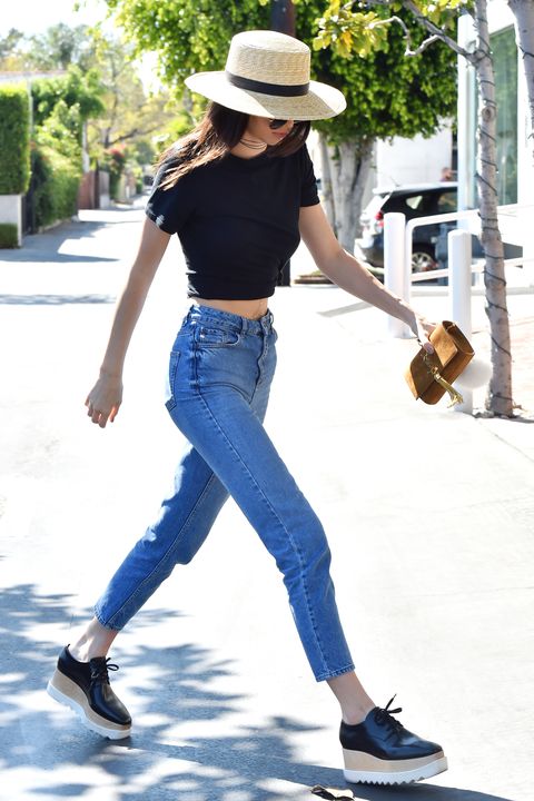 <p>In L.A., Jenner teamed her mom jeans with a black crop top and Stella McCartney shoes. The model's wide-brim hat shaded her from the paparazzi. </p>