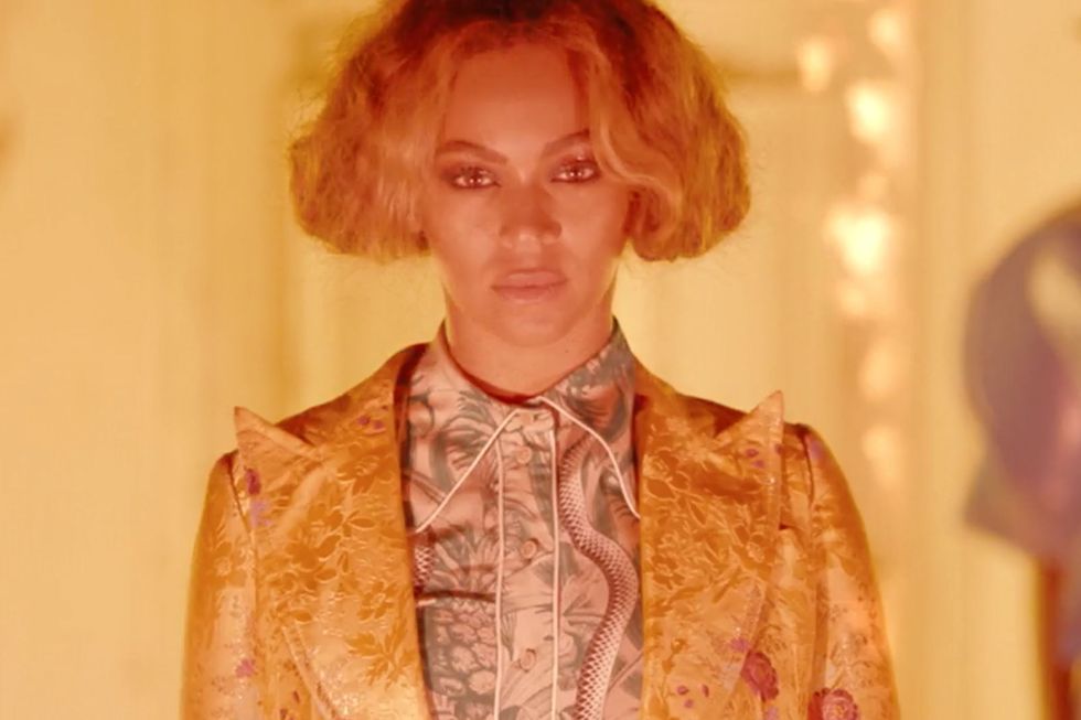 <p>The final exterior shot for "Six Inch" reveals Beyoncé in a floral Gucci suit, her braided up-do now transformed into a center-parted blunt bob with soft edges as she stands serenely in front of a house that's burning down.  </p>
