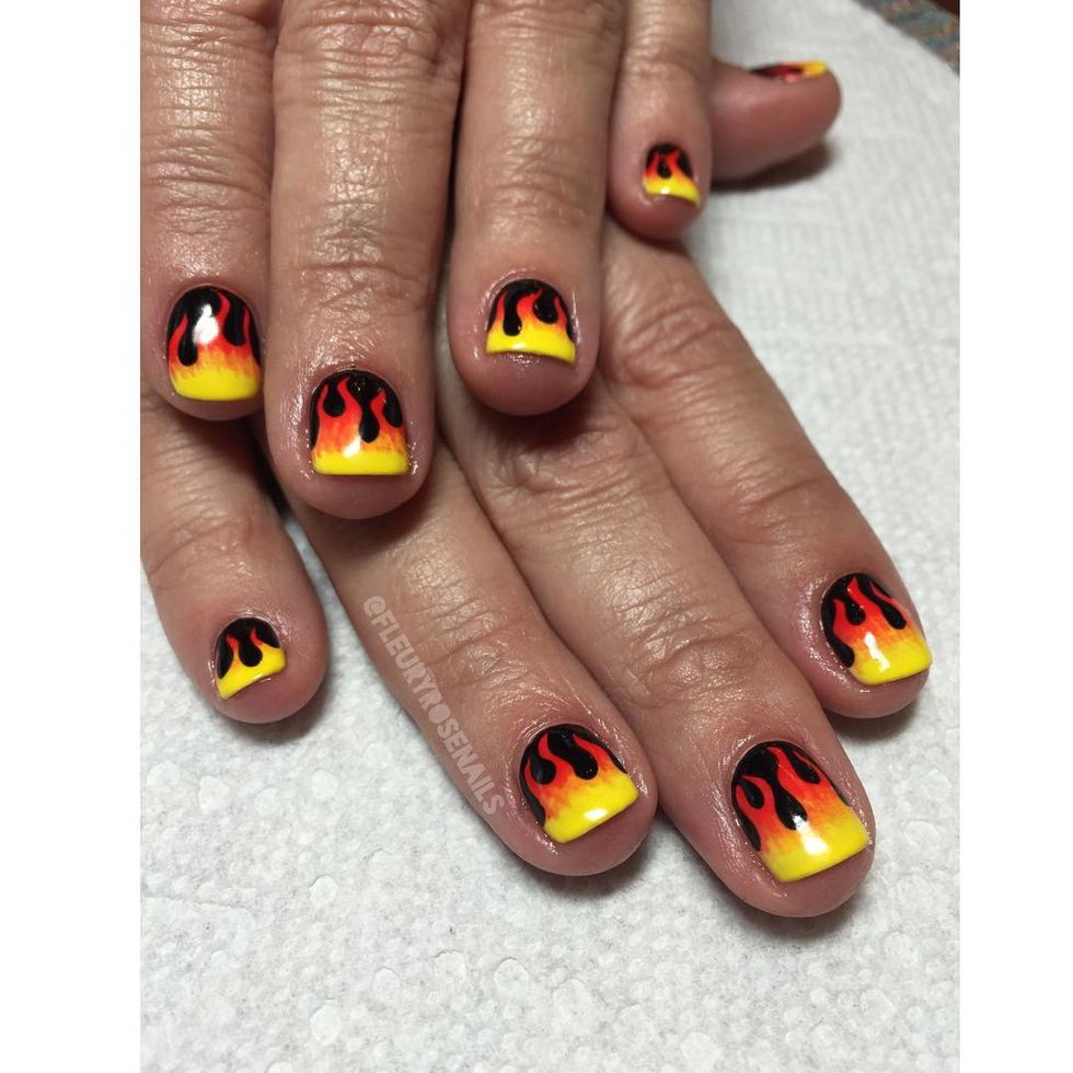 <p>Start with a black base coat. Create the swirling tips of the fire first in a bright orangey red near your cuticles. Apply a yellow polish at your tips and blend upward for a hand-painted <a href="http://www.elle.com/beauty/makeup-skin-care/g28435/ombre-nail-art/" target="_blank">ombre effect</a>. </p><p>Design by <a href="https://www.instagram.com/p/_z69PlKIQ7/" target="_blank">@fleuryrosenails</a></p>