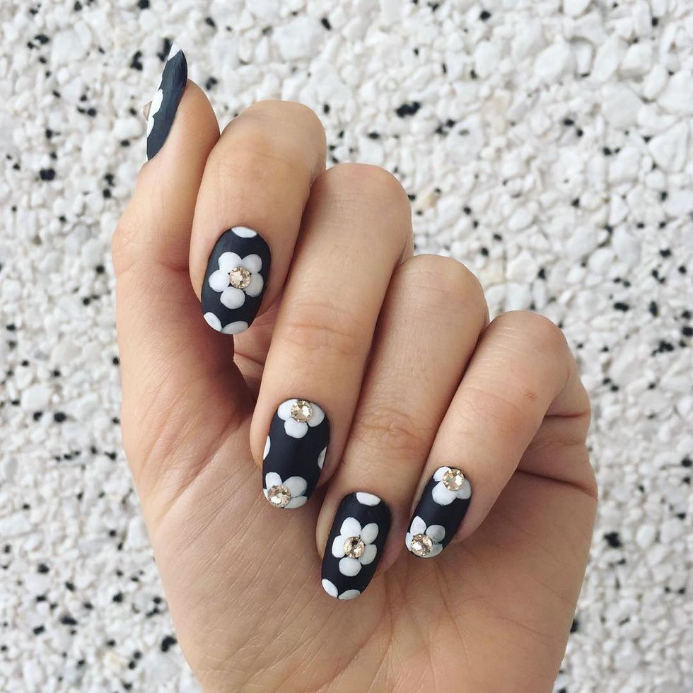 <p>For a textured floral nail, this design mixes matte polish, regular polish and embellishments. Start with a matte base. Let dry, then paint flower petals in a glossy hue. Finish the nail with crystal accents glued to the center of each flower.  </p><p>Design by <a href="https://www.instagram.com/p/BC_DlewkLUO/" target="_blank">@jessicawashick</a></p>